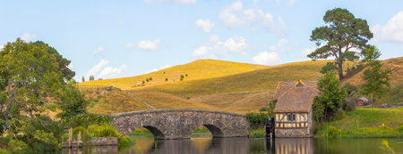 Suburban, rural landscape with a bridge and a mill.