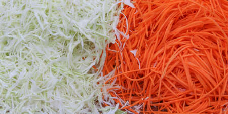 Sliced carrots and cabbage, the food is vegetarian.の写真素材