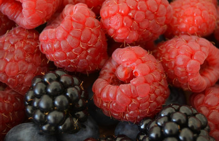 Fruits of ripe raspberries, blackberries and blueberries.