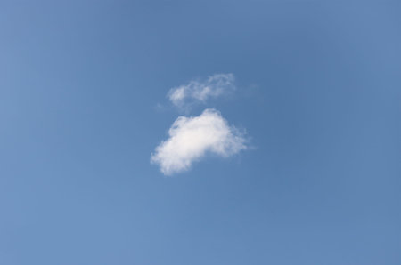 A single cloud against a blue summer sky.