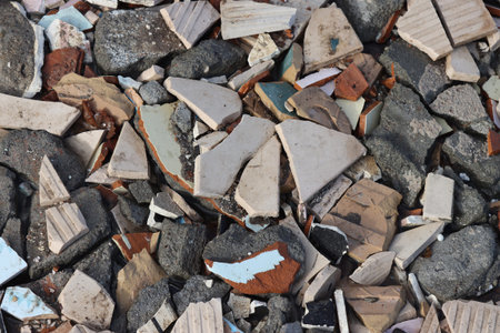 Construction waste, broken ceramic tiles and pieces of asphalt.
