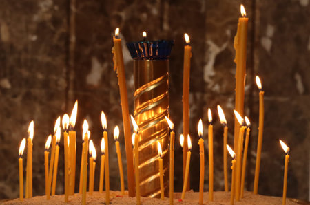 Wax candle burning in a religious church.