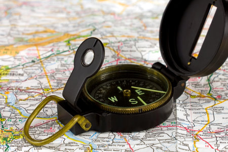 Close-up of a compass on a road map 