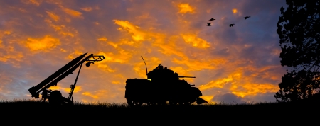 Silhouette of a Little John Missile and a tank against an evening sunset の写真素材
