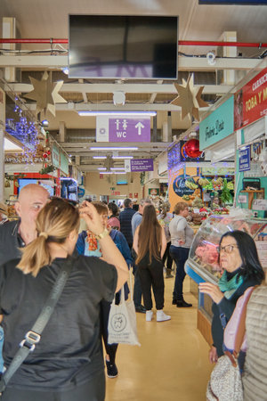 Tenerife, Spain - January 06, 2023: People doing their daily shopping in a municipal market full of stores in the concept of healthy and wholesome food with fresh local productsのeditorial素材