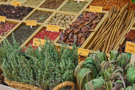 Assortment of spices and seasonings in insulated wooden fence containers with signs with name and price in eurosの写真素材