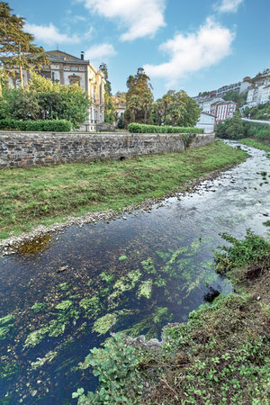 Sunny day on the famous black river that runs through Luarca in Asturias, Spain, without people and with beautiful clouds in the sky.の写真素材