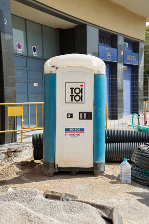 Viladecans, Spain - September 17, 2023: Portable temporary plastic bathroom for construction work on the street for workers.のeditorial素材