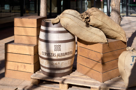 Barcelona, Spain - March 06, 2024: Jute sacks and a wooden barrel on a pallet, evoking a rustic,...