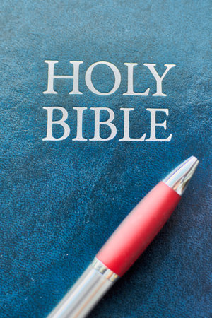 The Book of Mormon, offering another testament to the teachings of Jesus Christ with a pen.