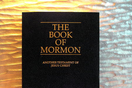 The Book of Mormon shines with golden letters, inviting readers to explore its pages offering an...
