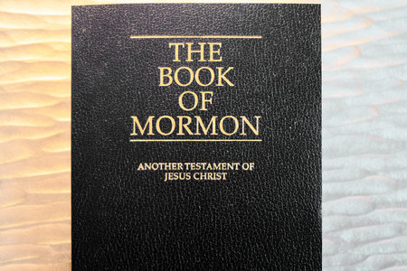 A close view of the sacred book of the Mormons, showing the embossed golden title on a textured...