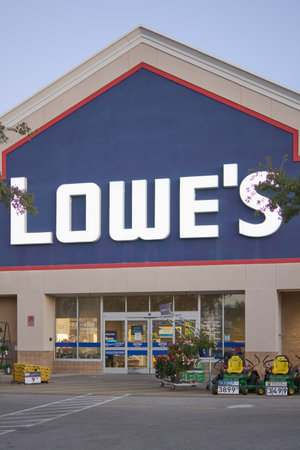 Florida, USA - March 23, 2024: Shot of a Lowe's store with a clear sky, showing the entrance filled with gardening tools and plants, inviting home improvement enthusiasts.のeditorial素材