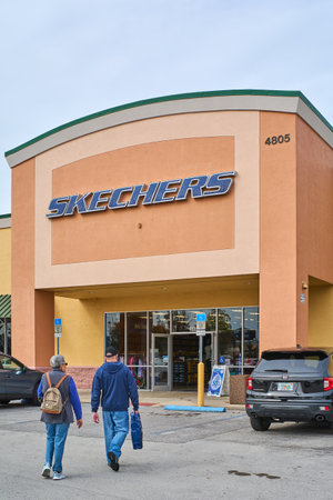 Florida, USA - March 23, 2024: The Skechers store is displayed in all its glory with a parking lot full of cars, indicating a busy day of shopping.のeditorial素材