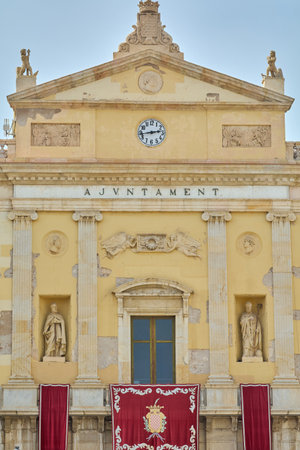Tarragona, Spain - April 17, 2024: Image of Tarragona Town Hall showing its classical architecture, detailed sculptures and a clock on top.のeditorial素材