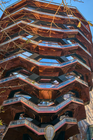 New York, USA - March 23, 2024: A clear sky accentuates the Vessel's majestic presence, making it a focal point in the bustling city surroundings.のeditorial素材