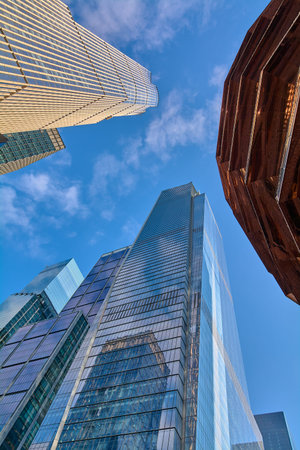New York, USA - March 23, 2024: The image highlights the contrast between traditional skyscrapers...
