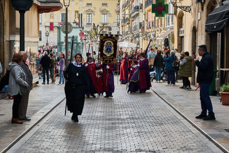 Tarragona, Spain - April 26, 2024: A Holy Week procession takes place on a street in Tarragona, with...
