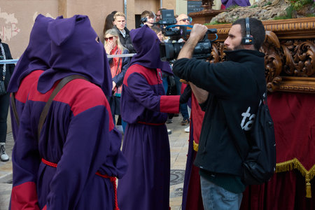 Tarragona, Spain - April 27, 2024: Vibrant scene of a religious procession with participants in...