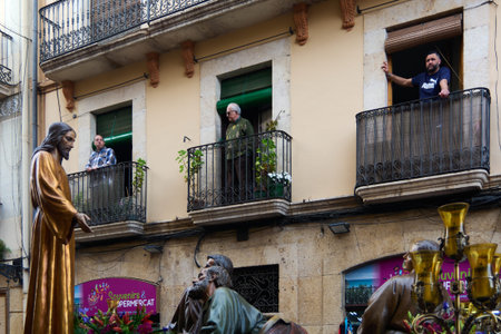 Tarragona, Spain - April 27, 2024: Image captures a Holy Week procession with religious statues and...