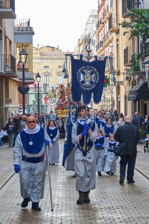 Tarragona, Spain - April 27, 2024: A traditional Holy Week procession takes place, with participants dressed as Nazarenes.のeditorial素材