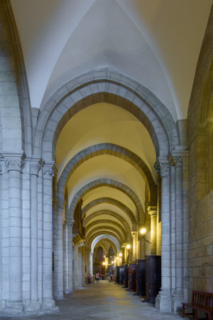 Lugo, Spain - May 10, 2024: Night view of illuminated arches at the Santa Maria Cathedral, showcasing a blend of ancient architecture and modern lights. A serene and elegant pathway inviting reflection.のeditorial素材