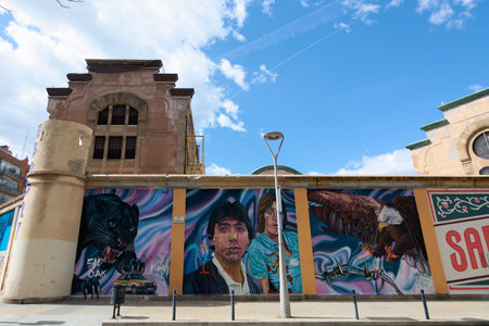 Barcelona, SPAIN - JULY 5, 2024: Street art depicting animals and criminals adorns the wall of the former model prison, fusing history with contemporary urban culture.のeditorial素材