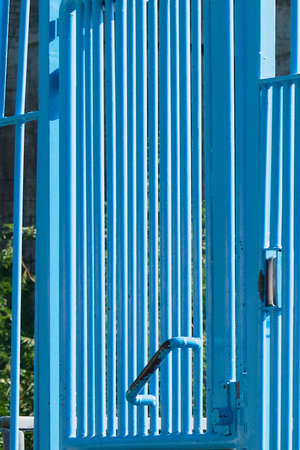 Blue iron gate with vertical barsの写真素材