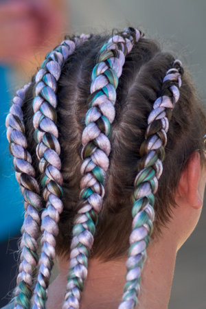 Detailed view of colorful braided strands forming intricate designs, emphasizing modern styling, vibrant hues, and precise craftsmanship.の写真素材