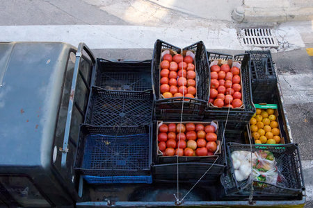 Overhead view of the back of a truck loaded with crates of ripe tomatoes, citrus, and other fresh produceの写真素材