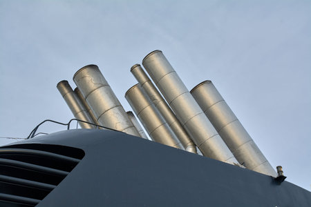 Detail of the industrial funnels of a large ship, symbolizing power and emissions.