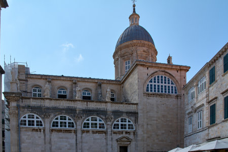 View of the Assumption Cathedral, a baroque landmark with a large dome and statues on its facade in Dubrovniks Old Town.の写真素材