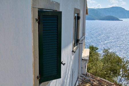 Traditional window with green shutters facing the Ionian Sea in Corfuの写真素材