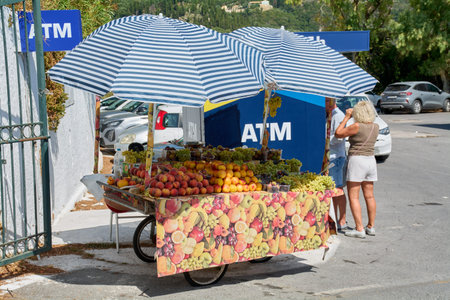 Corfu. Greece - January 22, 2026: Vibrant outdoor fruit cart in Greece featuring fresh seasonal...