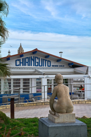 Sitges. Spain - February 15, 2026: Historic seafront chiringuito with prominent signage and seaside sculpture along the Mediterranean promenade in a renowned coastal resort.のeditorial素材