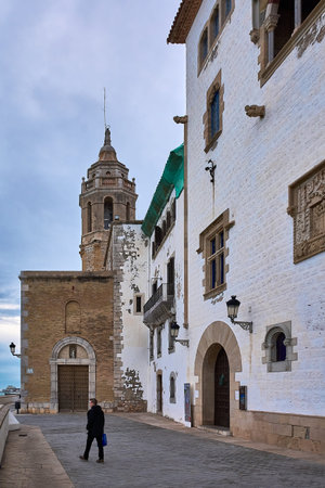 Sitges. Spain - February 18, 2026: Architectural details of traditional catholic church and adjoining buildings create timeless urban scene near the sea in Cataloniaのeditorial素材