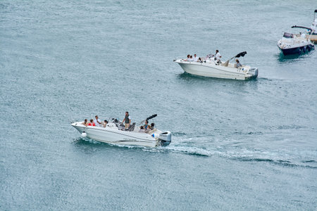 Kotor. Montenegro - March 24, 2026: Speedboats with tourists cruising through the blue waters of the...