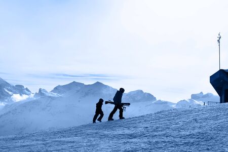 Ski slope. Skiers on the background of the Bernese Alps.の写真素材