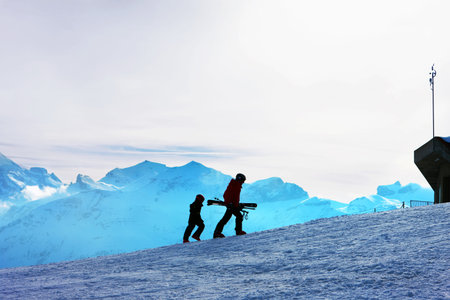 Ski slope. Skiers on the background of the Bernese Alps.の写真素材