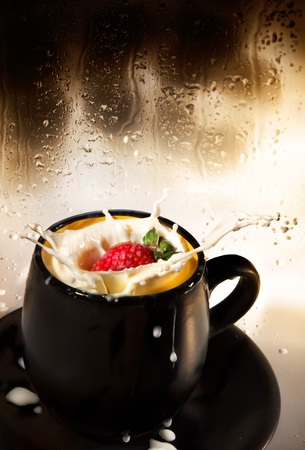 Strawberry splash in milk against the wet glass.の写真素材