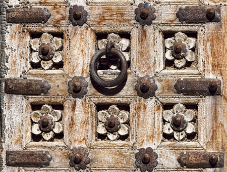 Old wooden door with floral decoration. Fragment. Rajasthan,Indiaの写真素材