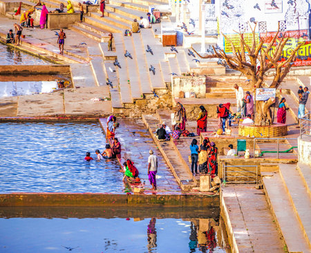 PUSHKAR, INDIA - NOVEMBER 20, 2012: Hindu pilgrims bathing in sacred Lake Pushkar (Sarovar) on...