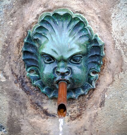 Head fountain in the wall in the form of the head in the Castle Ambras, Innsbruck, Austriaのeditorial素材