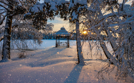 Sunset over a snowy lake and Parkの写真素材