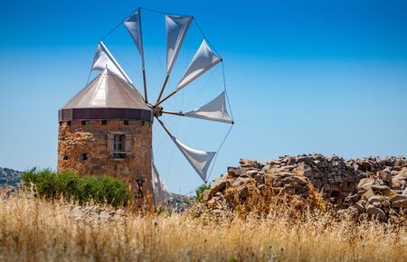 Old windmill in the mountains on the island of Crete, Greece.の写真素材