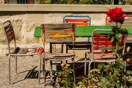 Old rusty chairs on a sunny terraceの写真素材