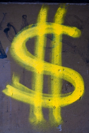 Yellow dollar sign wall graffitiの写真素材