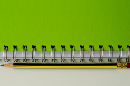 spiral green notebook and pencilの写真素材