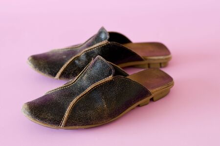 a pair of brown leather slippers の写真素材