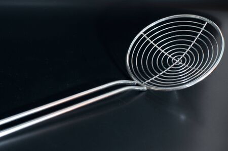 metal kitchen skimmer in a diagonal positionの写真素材